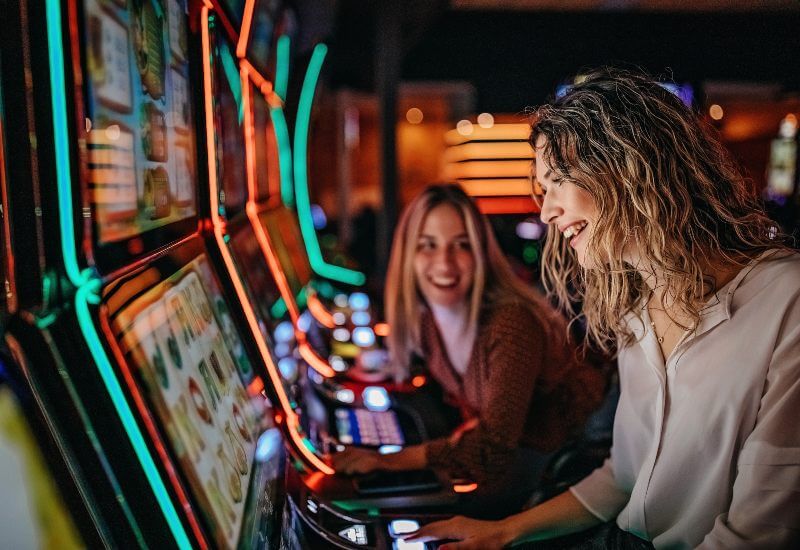 Close-up of players enjoying a slot machine in Black Hawk, CO, & the Denver metro